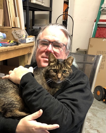 Photo of me with Esther in my lap. I’m sitting in a lawn chair in my garage and she is in my lap. I have my arms wrapped around her.