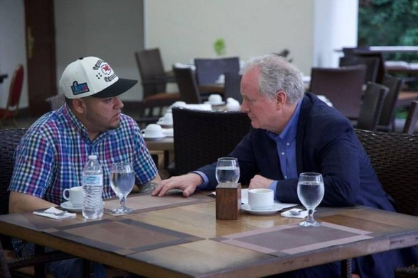 Kilmar Abrego Garcia seated at a table with Senator Chris VanHollen inside CECOT presumably from today.