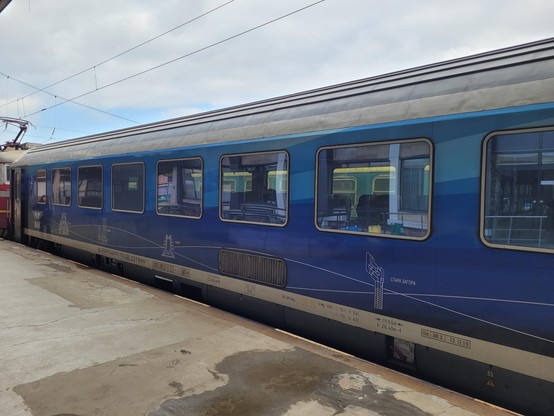 Presumably another former DB carriage but with a blue livery featuring Bulgarian cities.