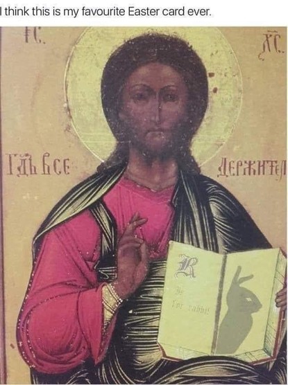 An Icon of Jesus holding and open bible.  He is holding his hand up as if giving a benediction.  On the open pages of the book, the hand is casting the shadow of a rabbit.