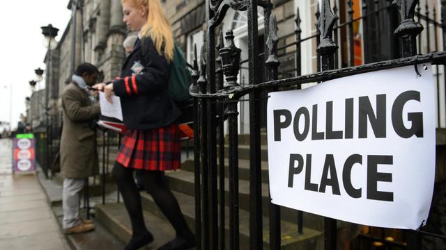 A school pupil leaves a polling station in Edinburgh, having cast her vote in Scotland's independence referendum on 18 September, 2014. | AFP - LEON NEAL