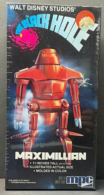 A picture of a toy package for the Maximilian figurine from the movie.   The package has a marketing image from the movie, with a space/starry background.   It appears to still have the shrink wrap on the package.